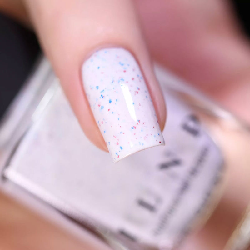 ILNP Liberty creamy white nail polish with blue and red metallic flakies swatch At Sea Collection